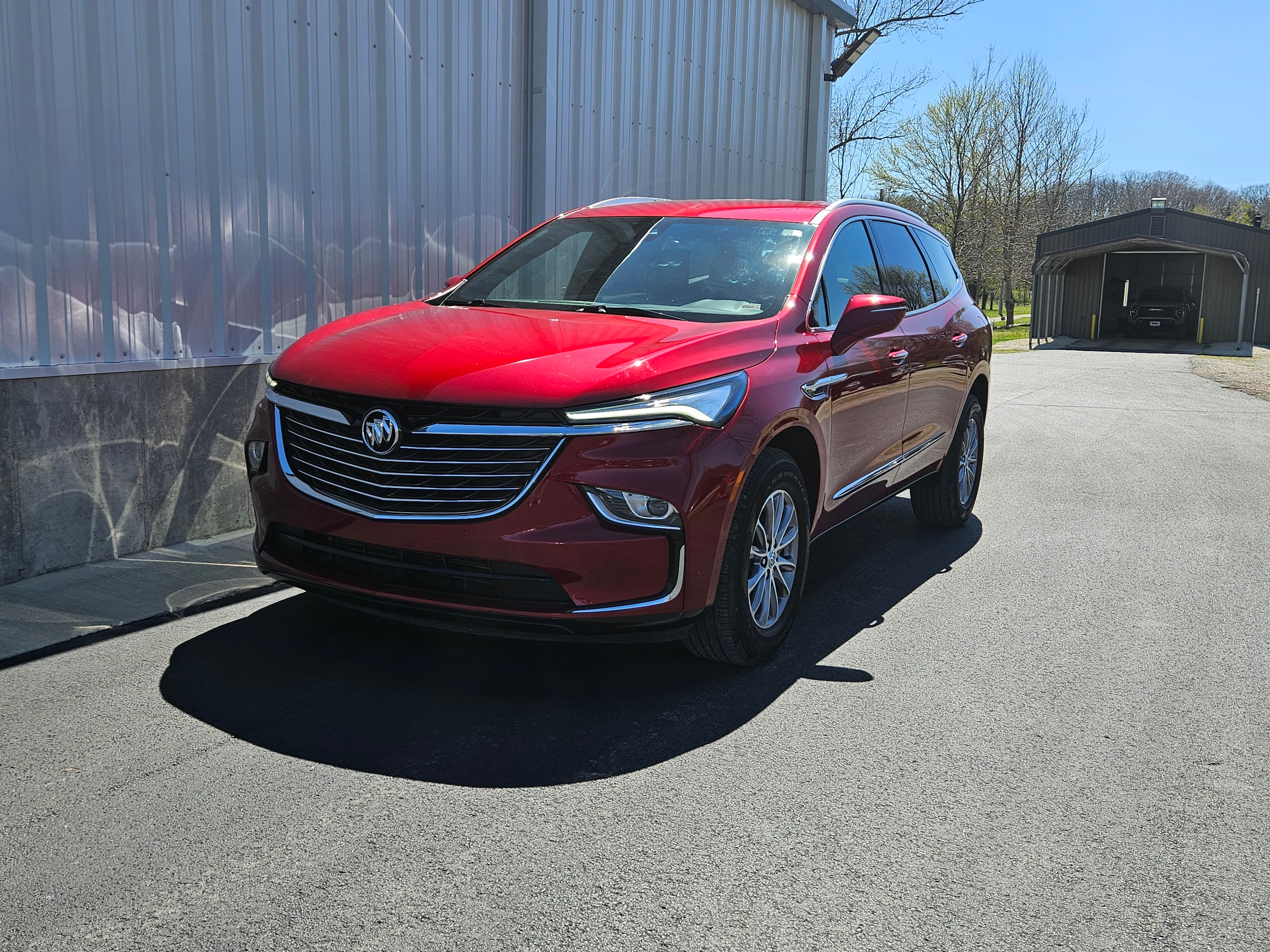 2023 Buick Enclave Essence in Cherry Red Tintcoat — front three-quarter view